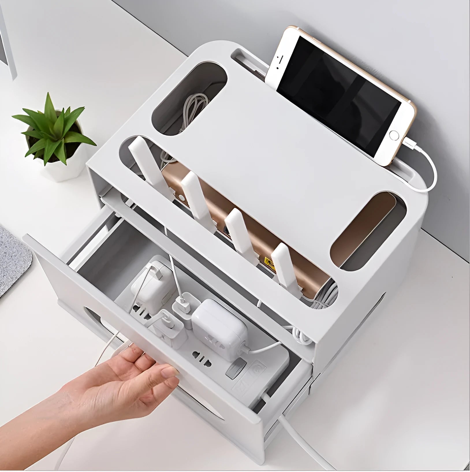 Grey and white plastic wireless router storage box with cable slots and ventilation holes.