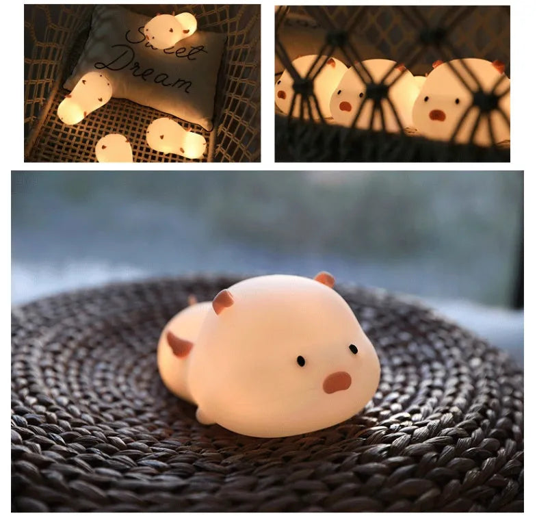 Blue silicone pig-shaped night light with sleeping design and USB charging port