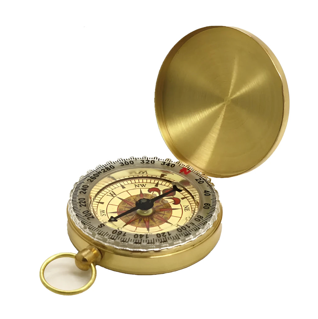Gold metal flip compass with open lid showing compass face, pocket watch style