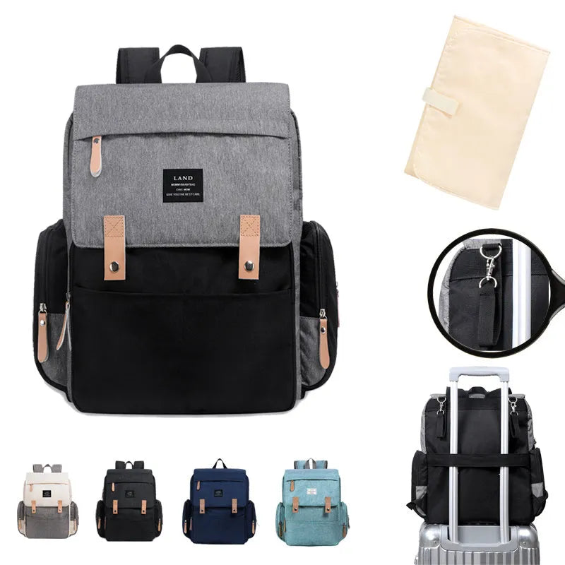 Land Mommy large oxford cloth diaper backpack in grey with a changing mat, shown open.