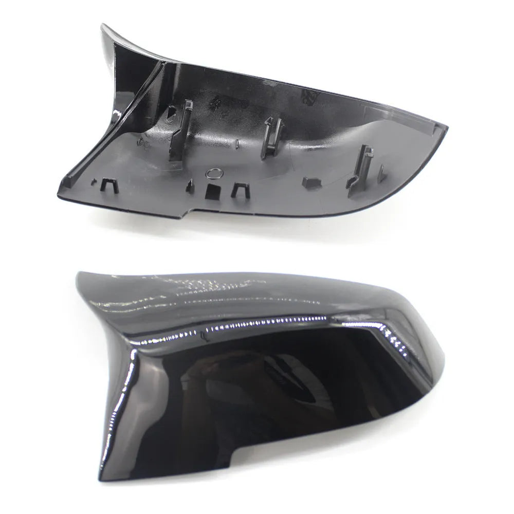 Pair of paint bright black BMW F-Series rear-view mirror replacement shells.