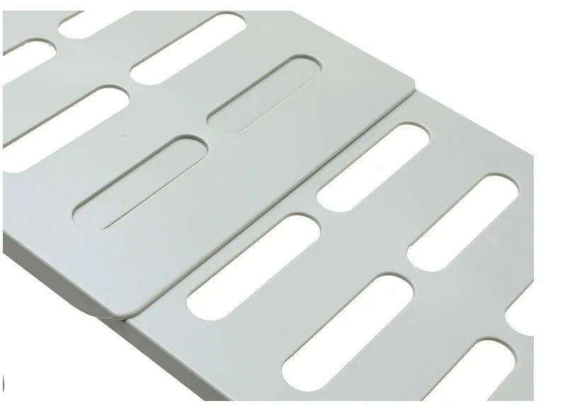White telescopic kitchen rack with adjustable height showing extended and compressed positions