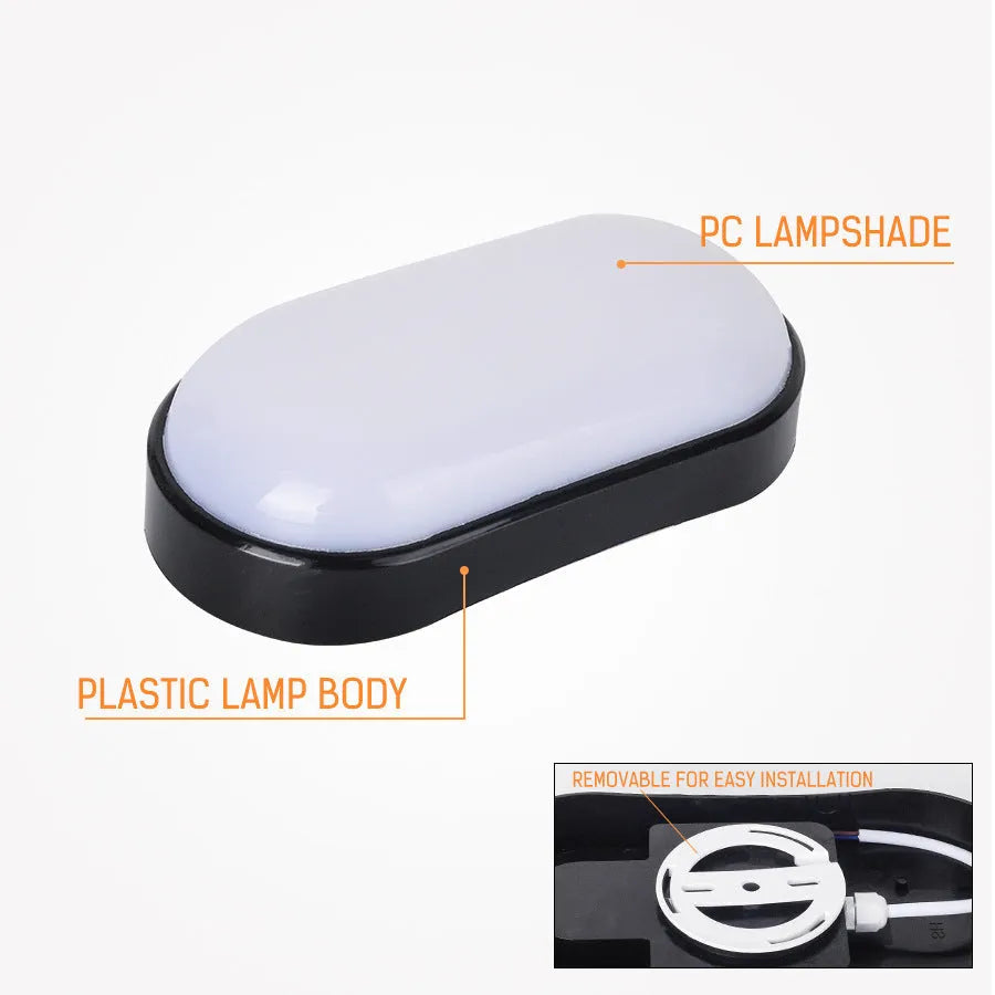 Black oval LED wall light surface mounted on a porch with warm white illumination