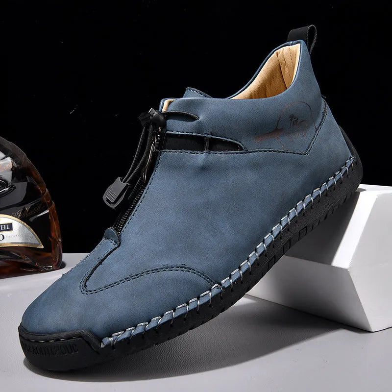 Casual men's leather travel shoes in black with rubber sole, mid heel, and round toe
