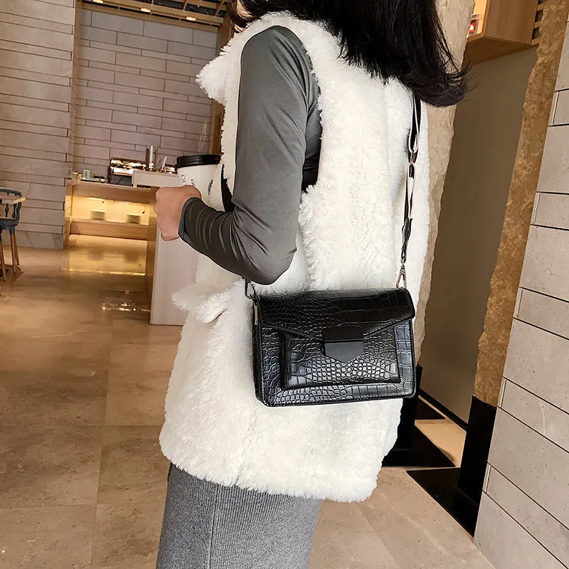 Vintage PU leather crossbody bag in black, shown with a mobile phone and wallet inside