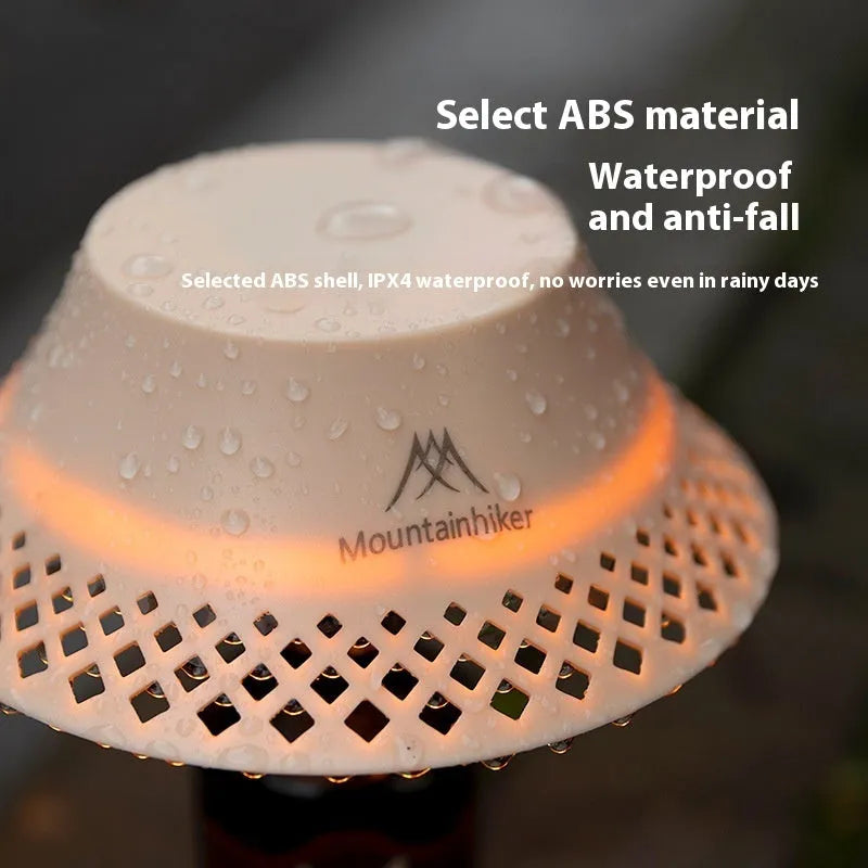 Beige wine bottle-shaped camping lantern with USB-C port and three light mode gear.