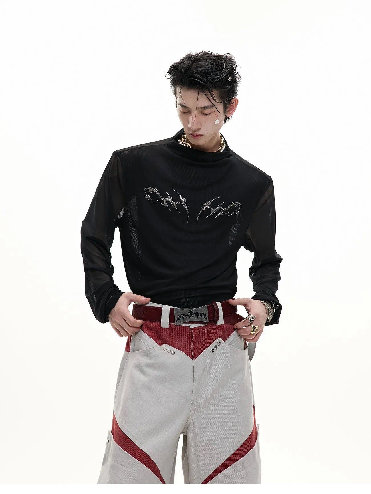 Slim-fit long-sleeved mesh shirt in black, shown as a base layer for athletic wear.