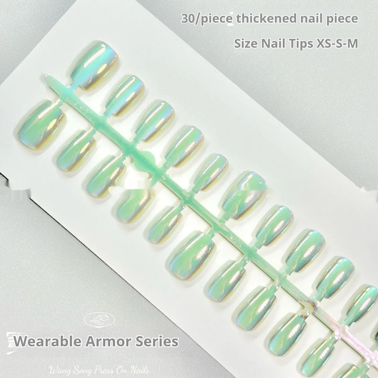 Set of electroplated Cat's Eye false nails in short ladder lengths on a clear stand.