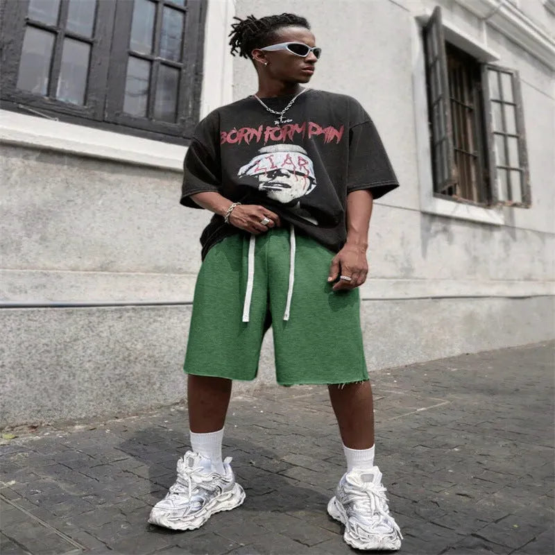 Men's straight leg polyester trousers in black, shown in a streetwear style pose.