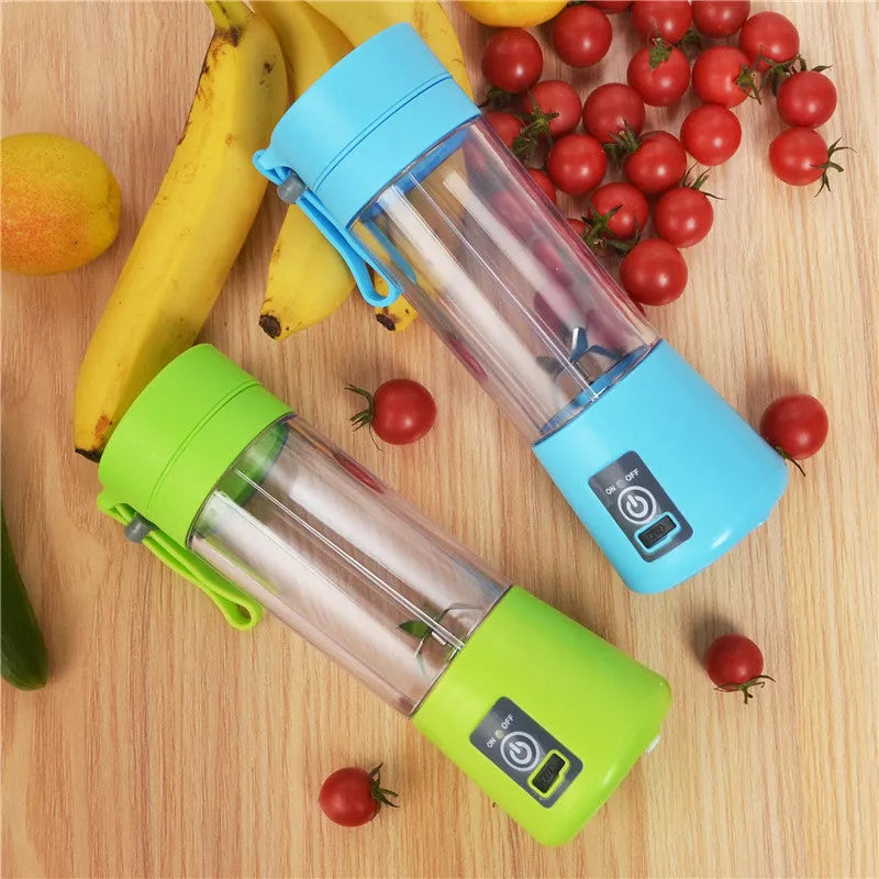 Pink mini USB electric fruit juicer with carrying rope on a kitchen countertop.