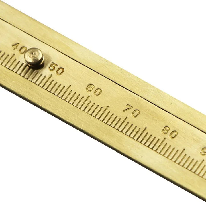 Double scale mini copper caliper with brass casting body and clear vernier markings on a white background
