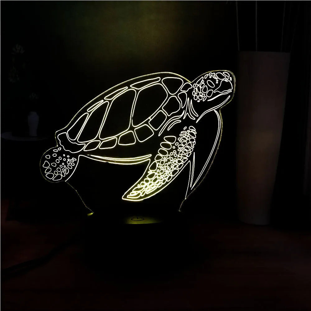 3D acrylic turtle-shaped LED night light with colour-changing illumination on a surface.