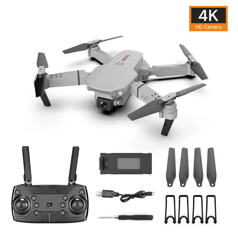 Grey foldable 4K dual camera aerial drone with remote control and spare blades