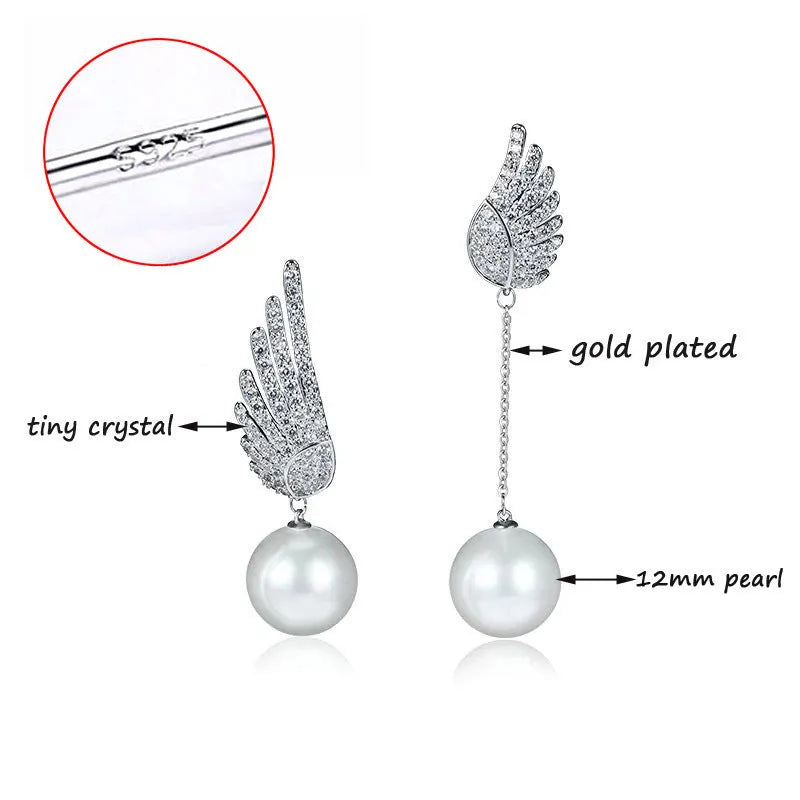 A pair of sterling silver angel wing earrings with diamond cut details and gold-plated gemstone inlay.
