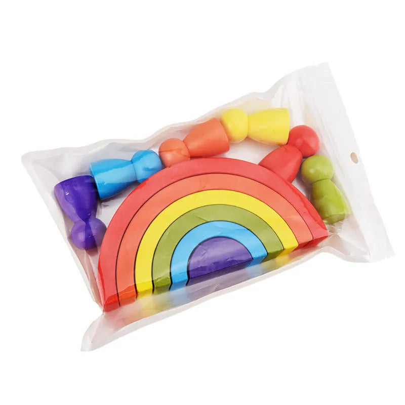 Rainbow arched wooden building blocks in a colourful stack on a flat surface