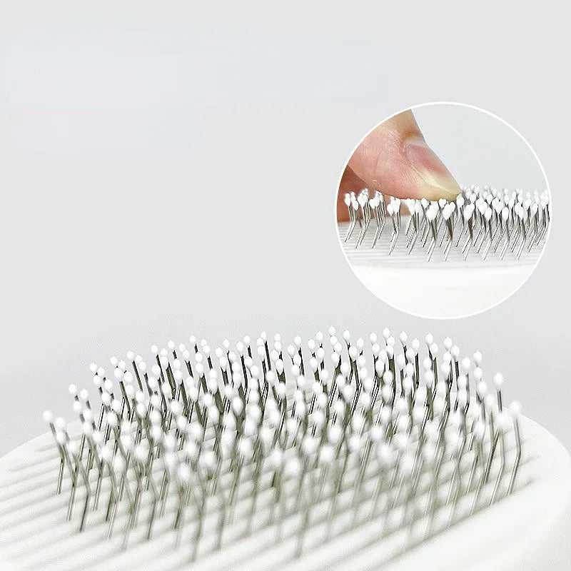 Self-cleaning pet grooming brush with stainless steel bristles and round massage beads for dogs and cats