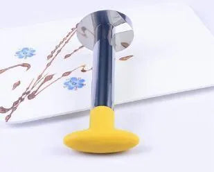 Stainless steel pineapple corer slicer with ABS handle on a kitchen worktop