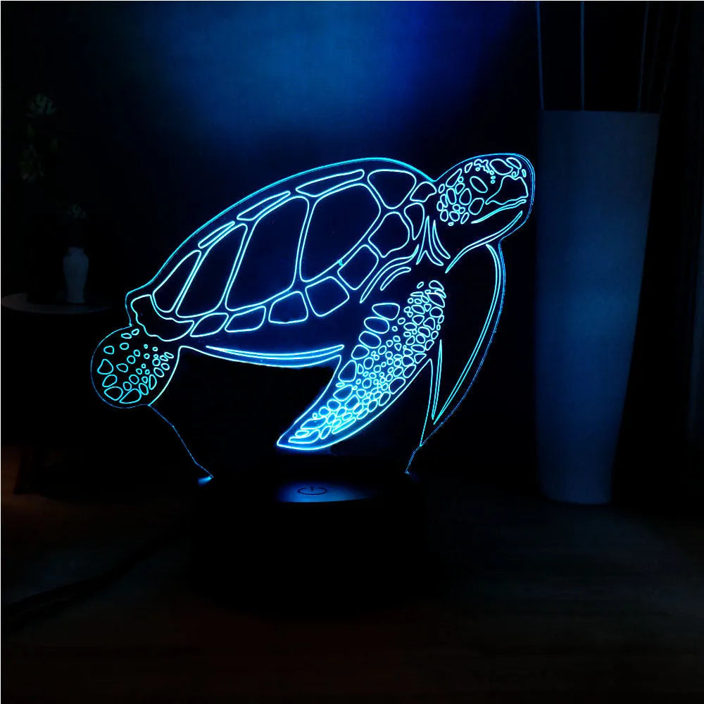 3D acrylic turtle-shaped LED night light with colour-changing illumination on a surface.