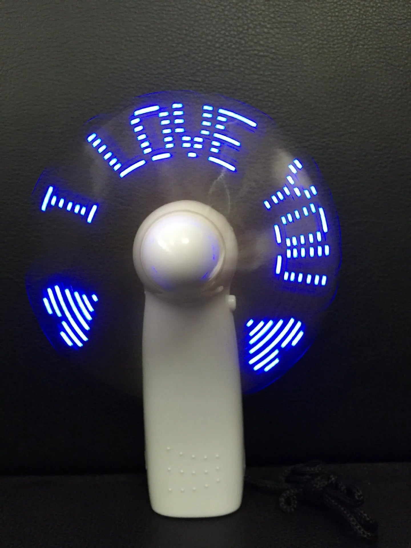 White mini handheld fan with blue and red LED love pattern display, showing dimensions.