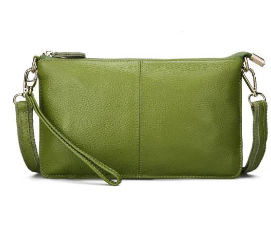 Lady's cowhide leather slant bag in apricot colour with hand strap and shoulder strap showing zipper compartments