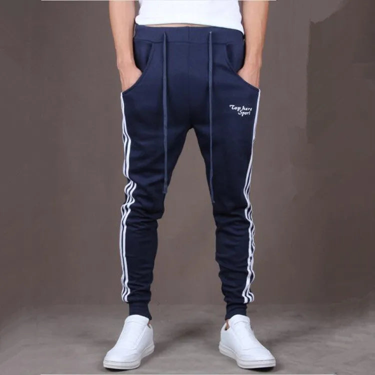 Men's straight leg cotton casual trousers with three-bar side stripe in grey, black, and navy