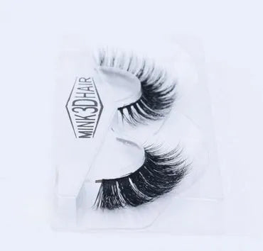 Pair of faux mink eyelashes with long tail and cotton stem against white background