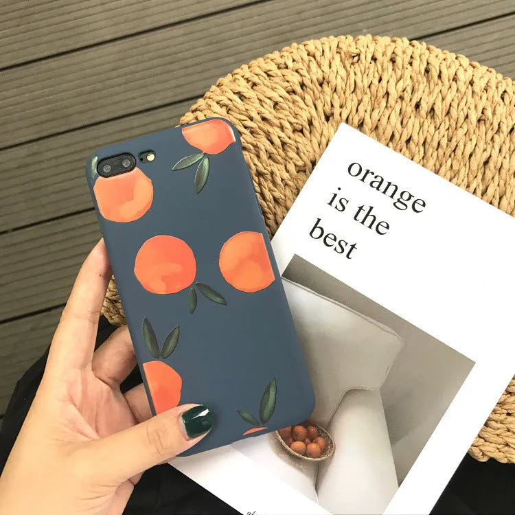 Orange matte finish TPU silicone case for iPhone on a table.