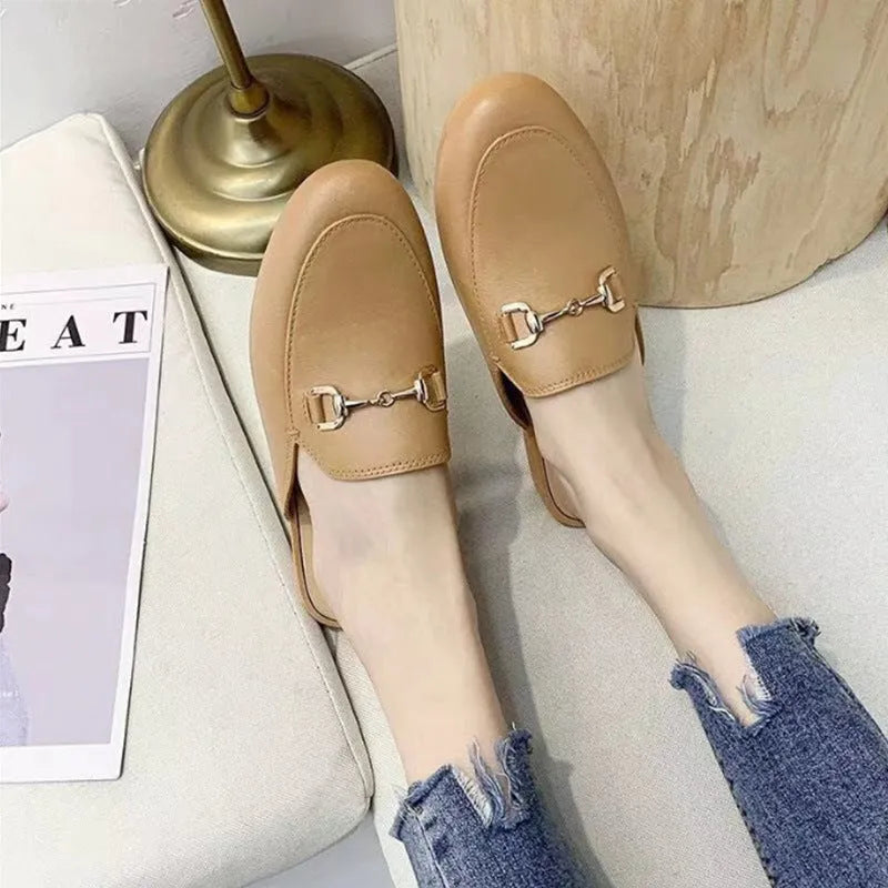 Women's PVC closed toe half slipper with metal buckle fastening in milky white.