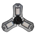 A foldable silver industrial LED garage lamp with a polycarbonate lens, shown in a workshop setting.
