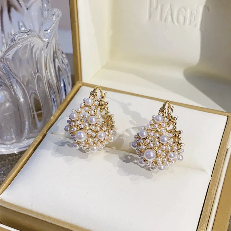 Gold floral basket earrings with pearl inlay and rice-shaped bead construction
