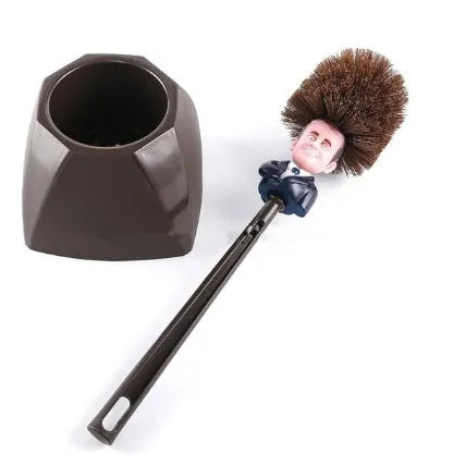 Yellow plastic Donald Trump toilet brush with hanging slot on handle.