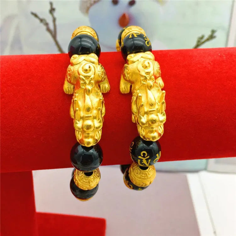 Vietnamese sand gold gold-plated brave bracelet with black beads on display