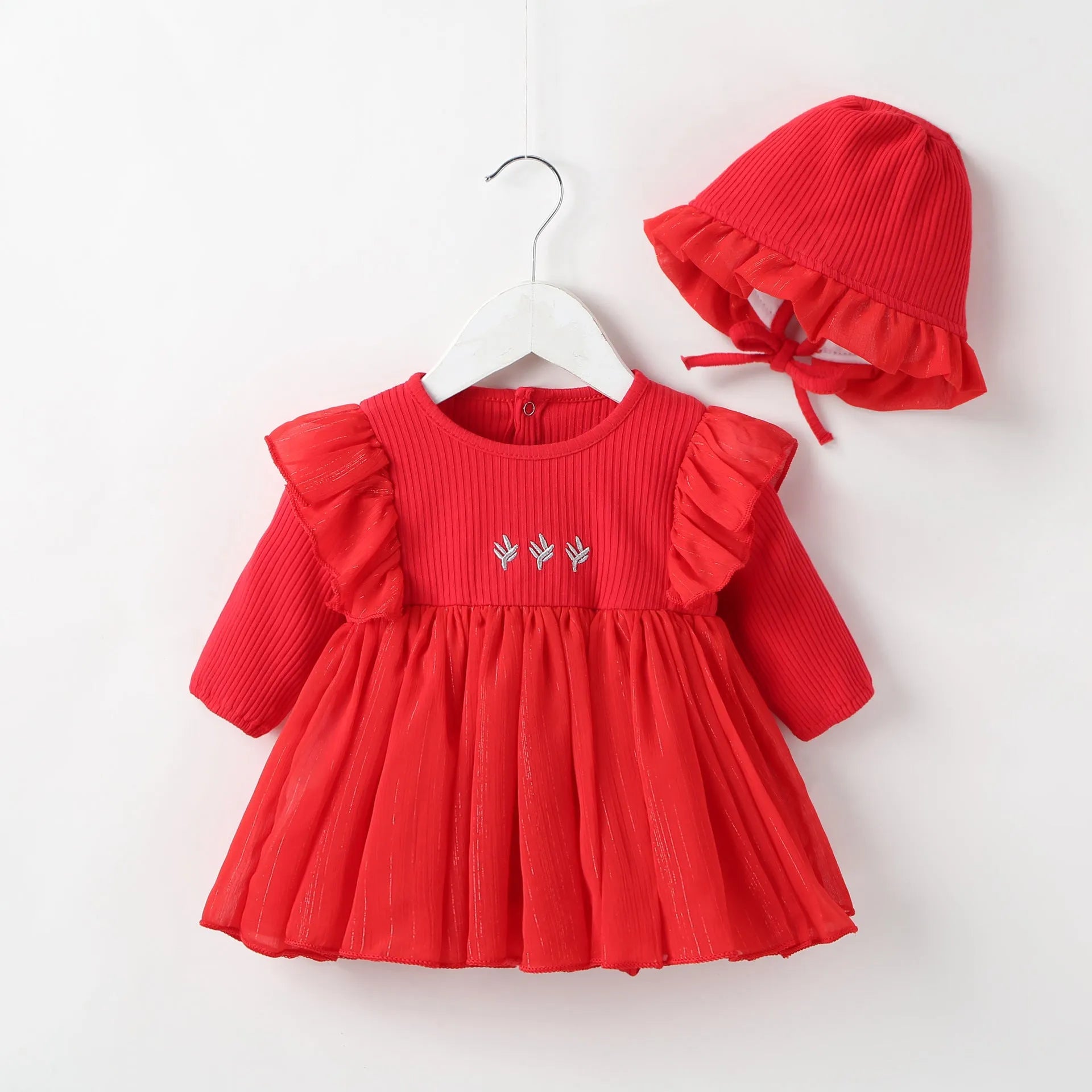 Baby girl in a soft pink cotton princess dress with a fluffy skirt, suitable for a first birthday party.