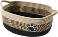 Light beige handmade woven cotton rope storage basket with wooden handle.
