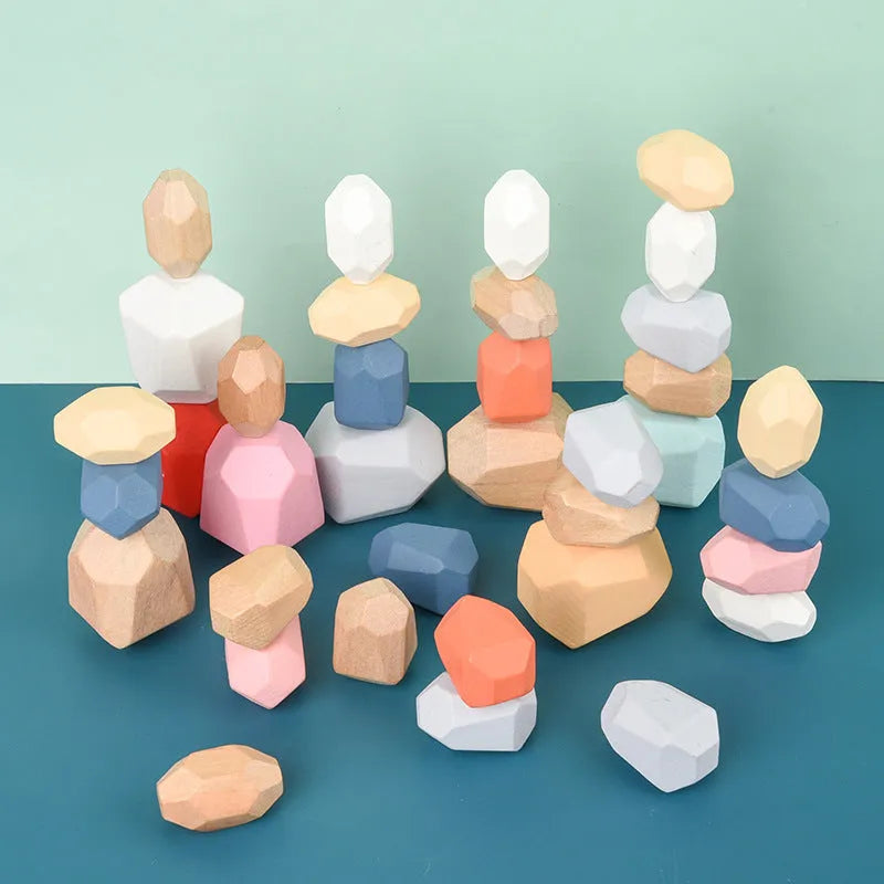 Wooden building block set with coloured and natural stone stacks on a table, suitable for children aged 4-6