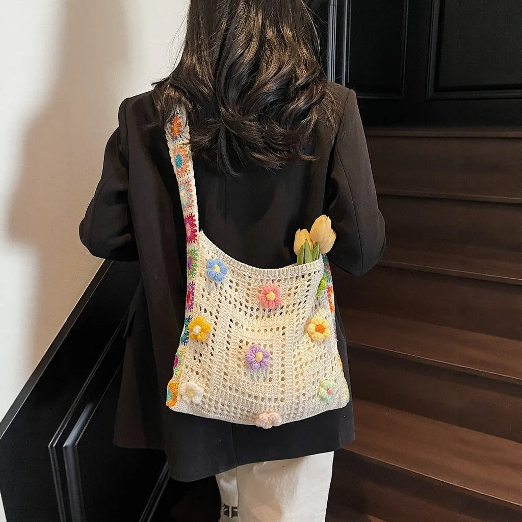 Woven beach shoulder bag with hollow weave pattern showing adjustable strap and interior