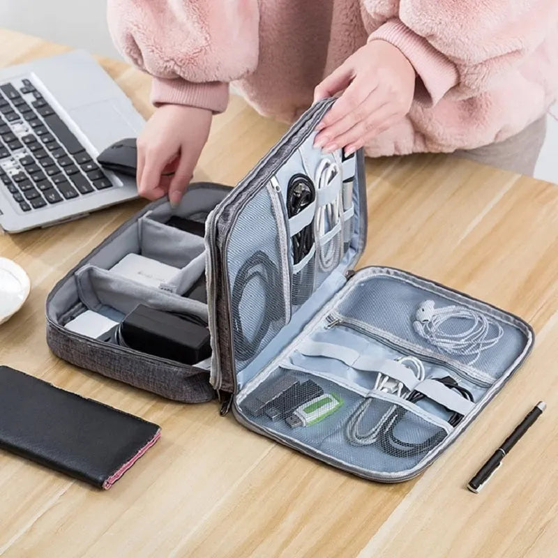 Gray waterproof double-layer electronics organizer bag with adjustable dividers and carrying handle, open to show elastic loops and mesh pockets