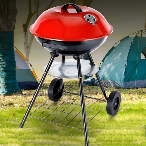 A portable cast iron barbecue oven with a 14-inch cooking surface, shown outdoors.