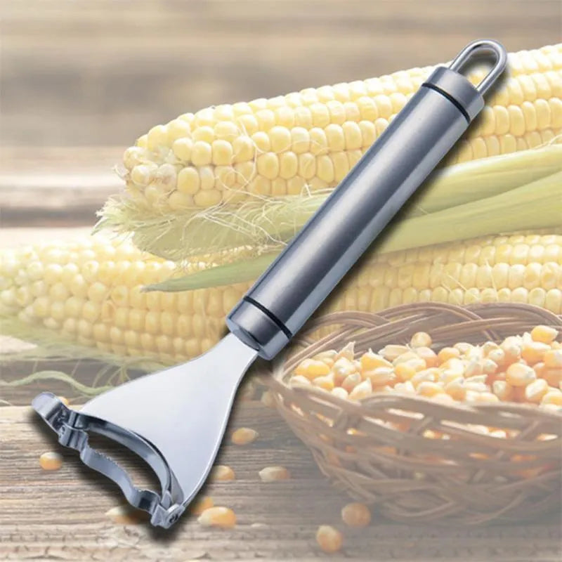 Stainless steel corn planer kitchen tool on a wooden surface