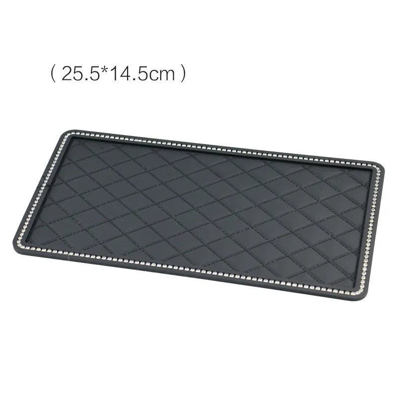 Black silicone car anti-slip mat on dashboard holding a mobile phone L size