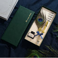 Retro green peacock feather pen set with ink bottle, base, and replacement nibs in box