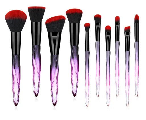 Ten crystal-handle foundation brushes with artificial fibre bristles in a set, showing black, blue, red, and yellow colour options.