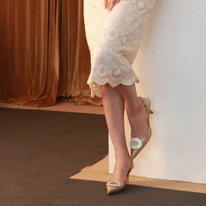 Red satin rhinestone high heel pump with pointed toe and buckle strap on stiletto heel