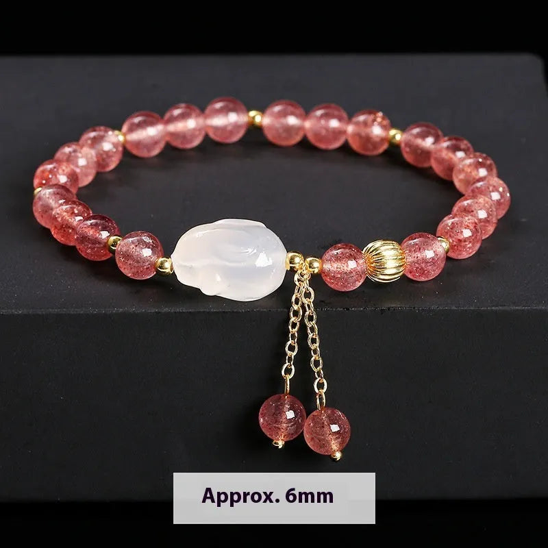 Handmade women's bracelet with natural strawberry quartz and agate 6mm round beads on a wrist.