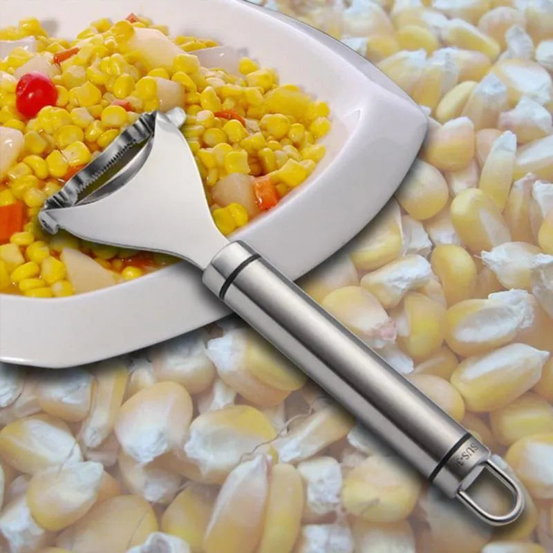 Stainless steel corn planer kitchen tool on a wooden surface