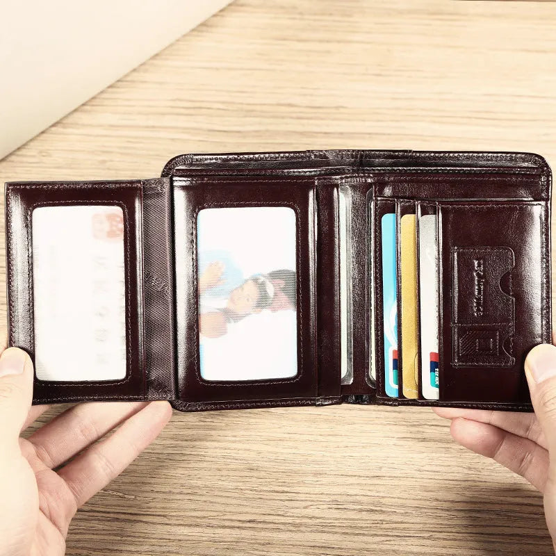 Men's black leather bi-fold wallet open to show card slots, banknote compartment, and coin pocket.
