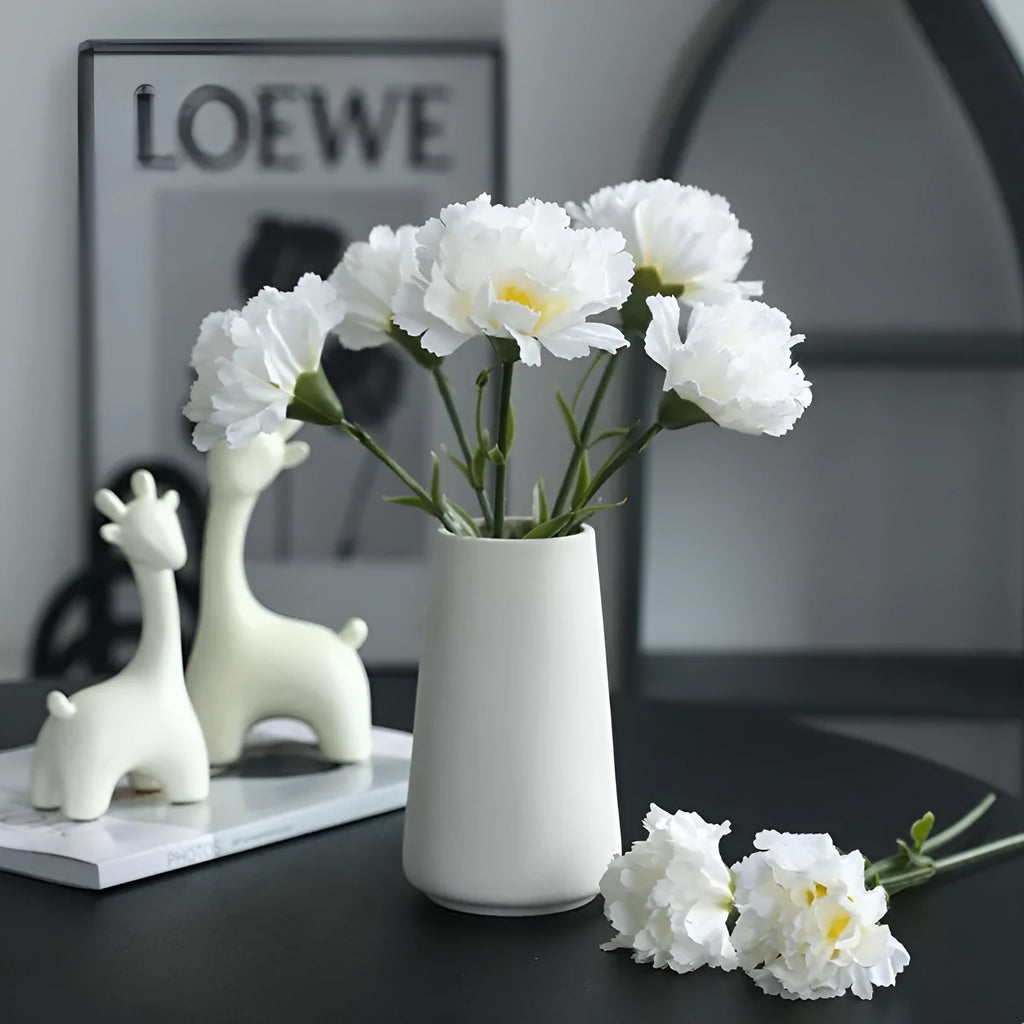 Single artificial mini carnation fake flower in soft rubber and silk material on white background