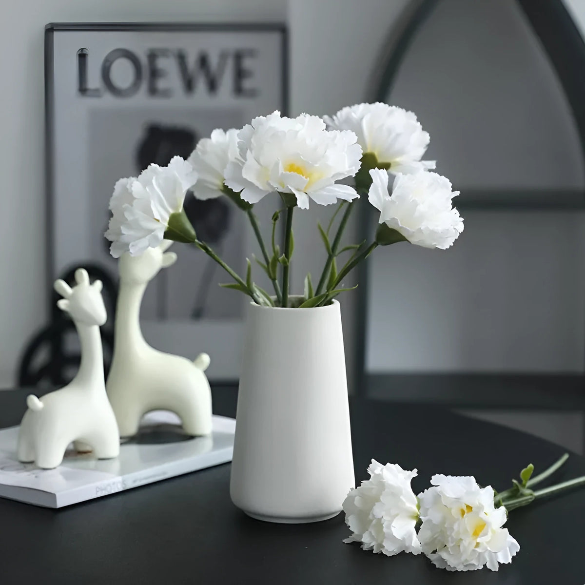 Single artificial mini carnation fake flower in soft rubber and silk material on white background