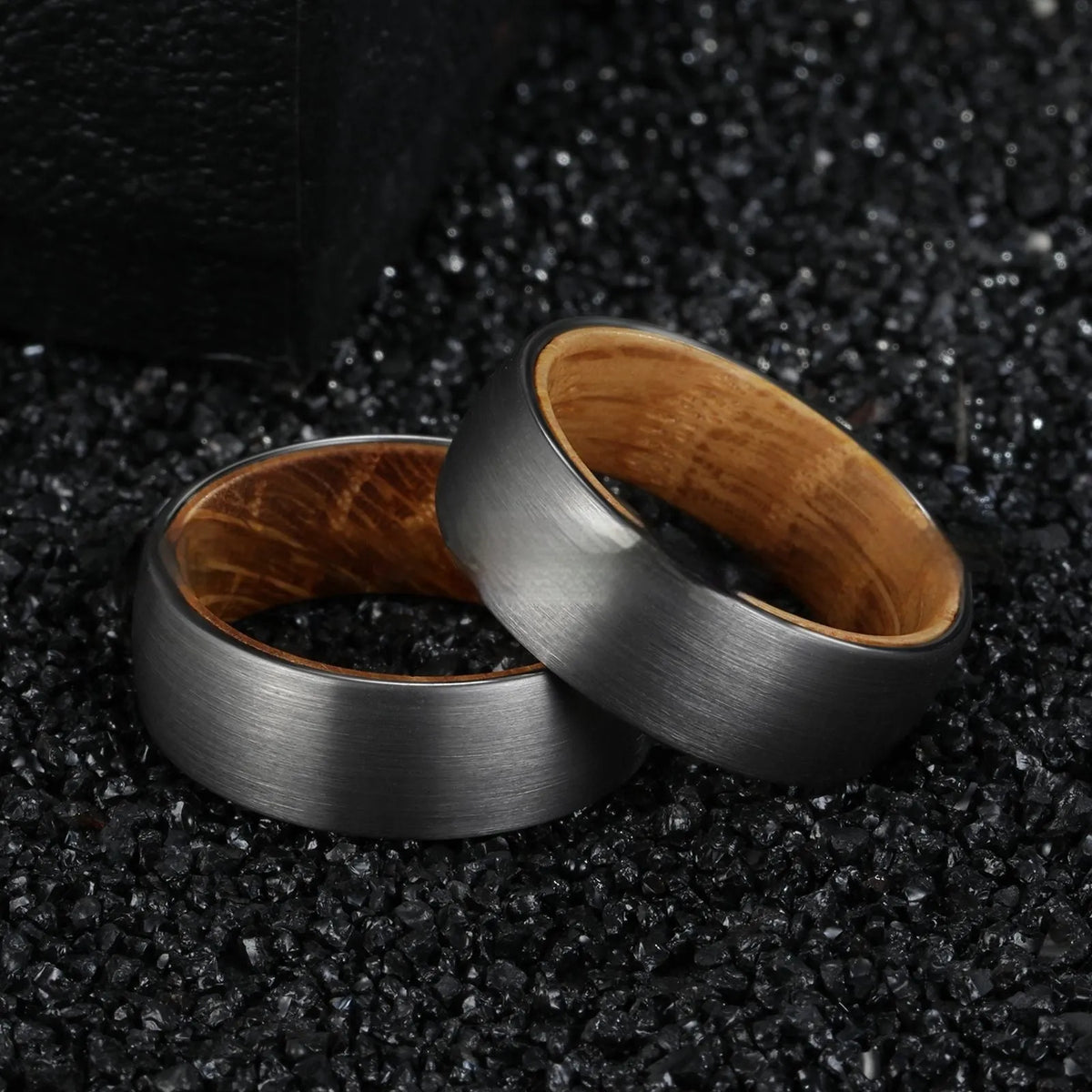 Silver tungsten ring with barrel wood inlay for men, simple band on light background