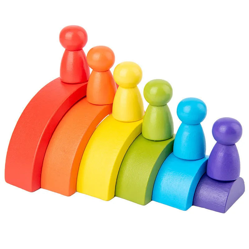 Rainbow arched wooden building blocks in a colourful stack on a flat surface
